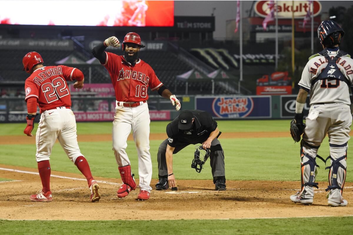 Angels outfielder Brian Goodwin celebrates after hitting a two-run home run against the Astros at Angel Stadium.