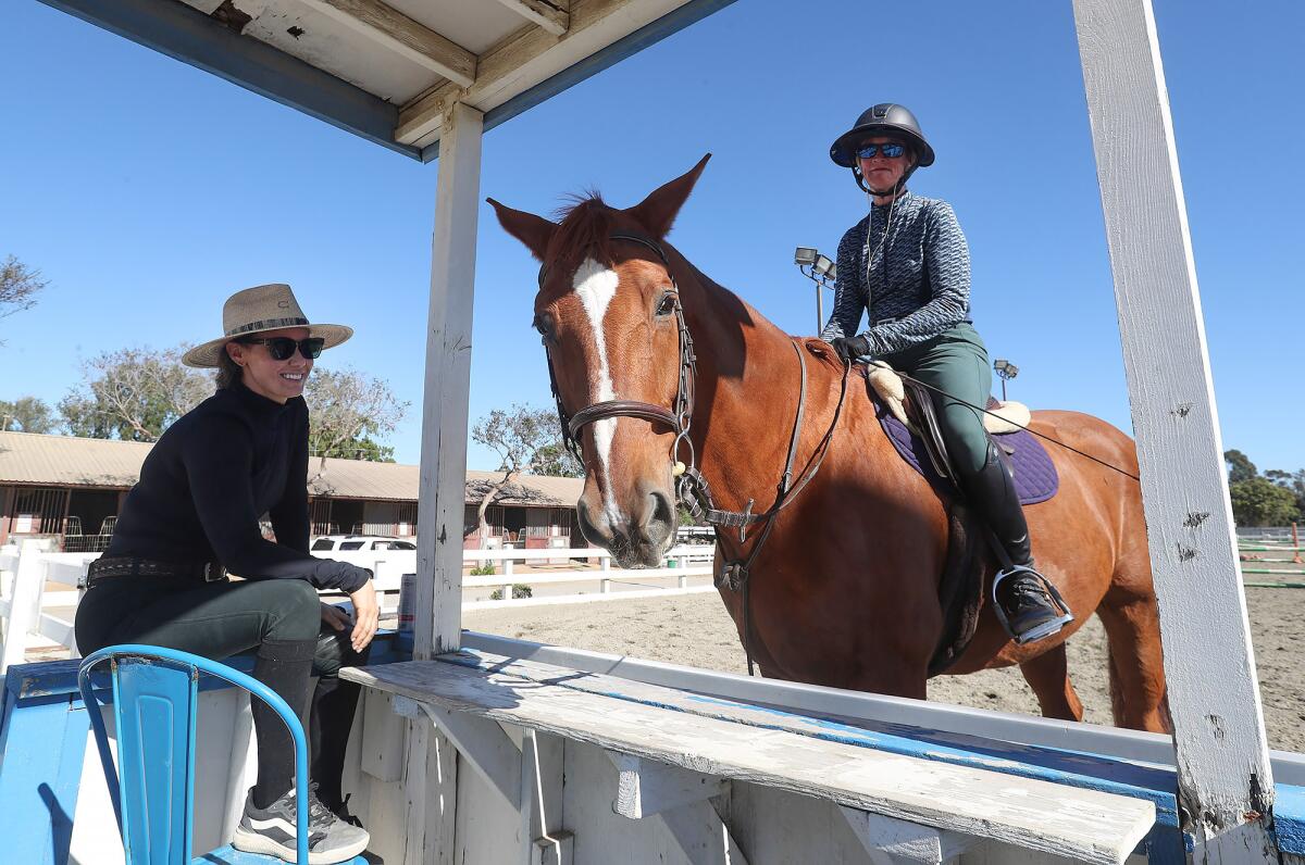 Trainer Sarah Klifa, left, from Coeval Training works with client Carolyn Beaver, astride Don Juan.