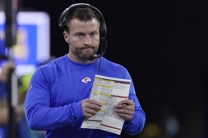 Rams coach Sean McVay walks on the sideline during a playoff game against the Arizona Cardinals 