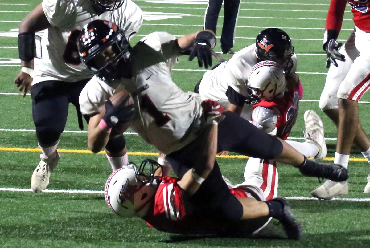 Los Amigos' Alex Le (1) scores to increase the Lobos' lead to 21-14 over Bolsa Grande.