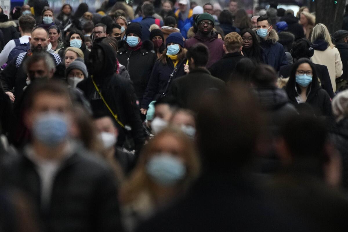 Shoppers in masks on a busy London street.