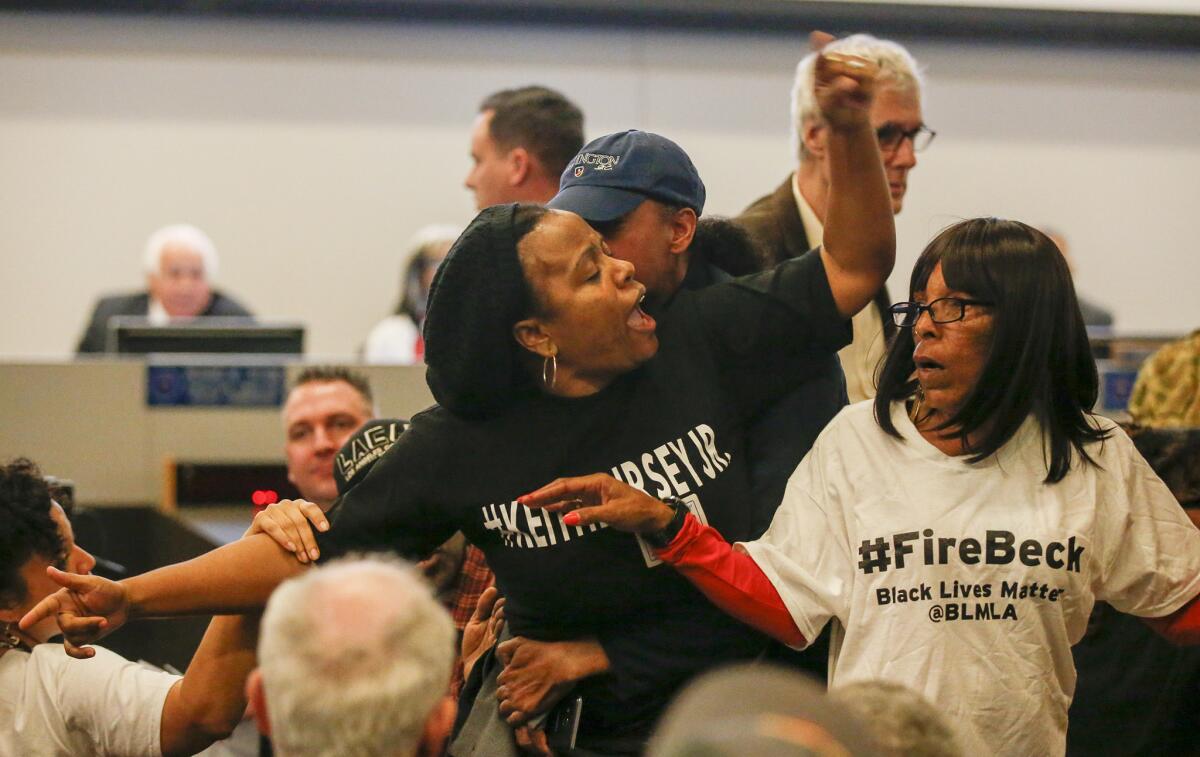 Tensions flare between family members and friends of a man killed by an LAPD officer. The Police Commission was meeting to discuss new rules for the use of deadly force. (Mark Boster / Los Angeles Times)