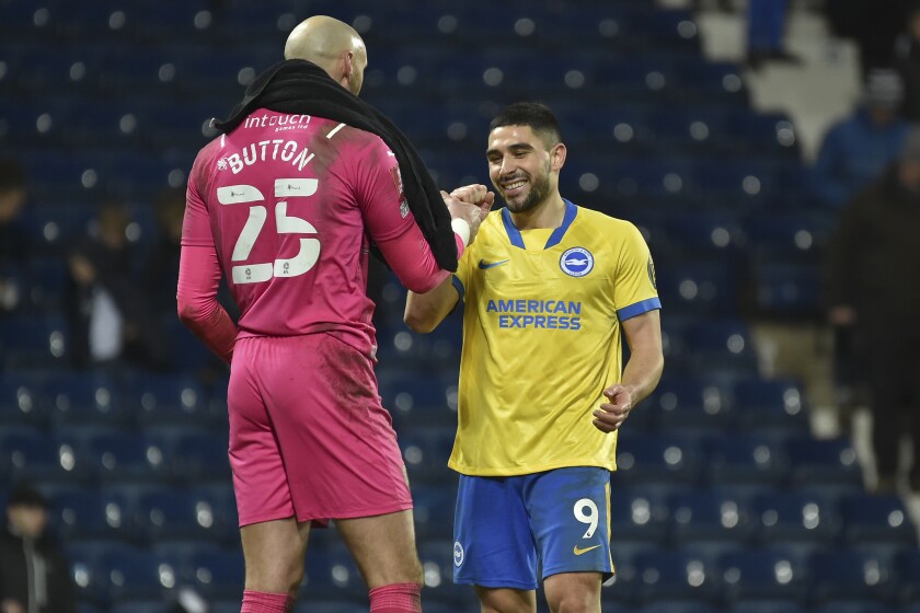 Brighton's Neal Maupay, right, greets West Bromwich Albion's goalkeeper David Button after the English FA Cup third round soccer match between West Bromwich Albion and Brighton & Hove Albion at the Hawthorns, West Bromwich, England, Saturday, Jan. 8, 2022. Brighton won 2-1 after extra time. (AP Photo/Rui Vieira)
