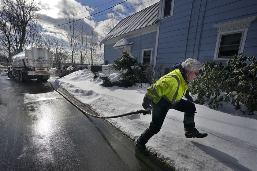 Peter Ellingwood delivers heating oil, Tuesday, Jan. 31, 2023, in Farmington, Maine. On Friday, the U.S. government issues the January jobs report. (AP Photo/Robert F. Bukaty)
