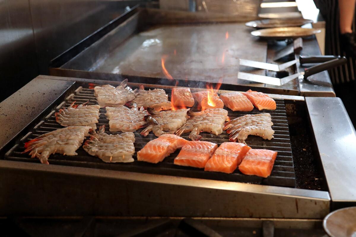 Mexican white shrimp and Norwegian Salmon on the grill at O Sea restaurant in Old Town Orange.