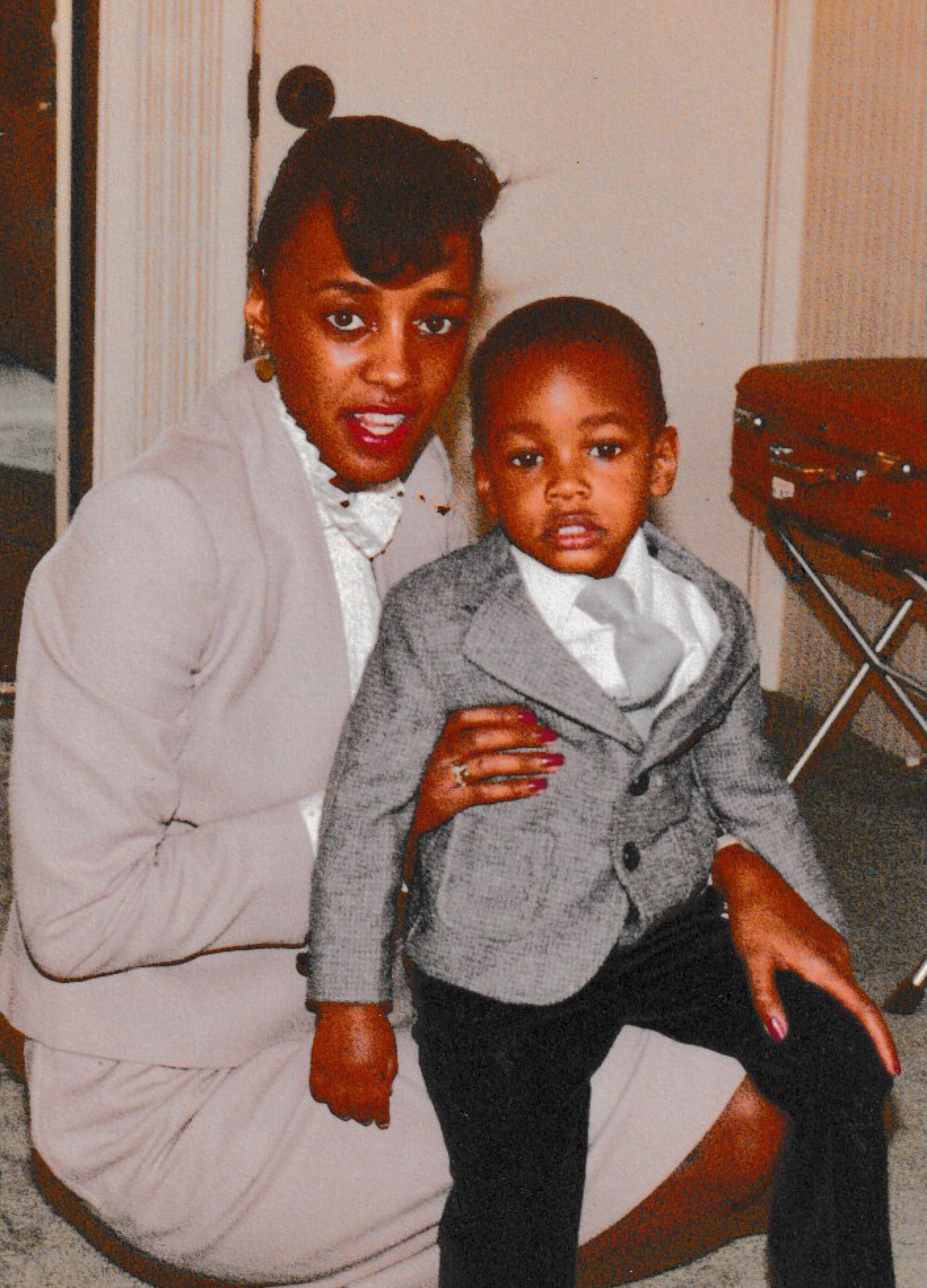 Pulane Lucas holds her son, Stanley Wilson Jr., on her lap inside a hotel room.