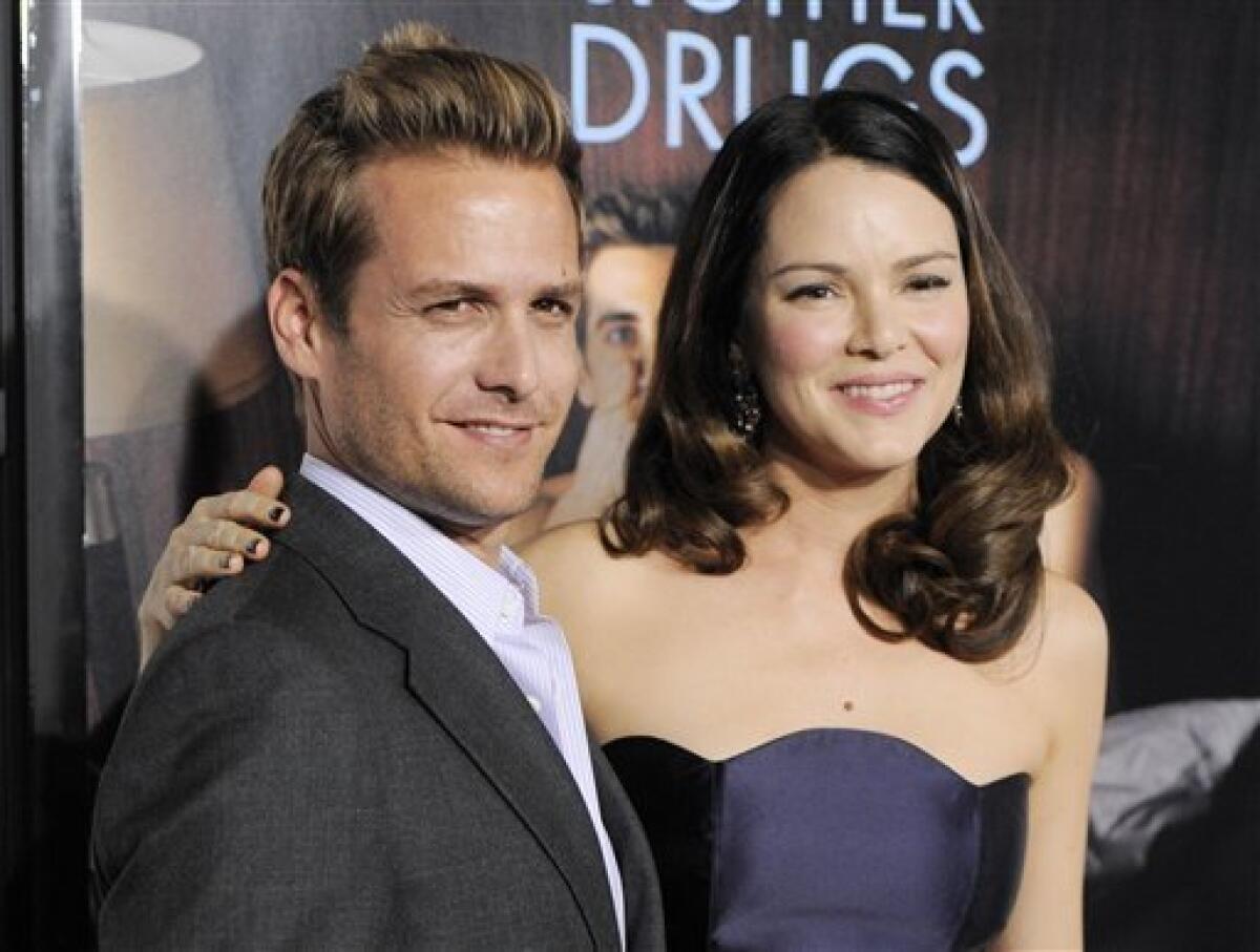 FILE - This Nov. 4, 2010 file photo shows actors Gabriel Macht, left, and his wife, actress Jacinda Barrett at the premiere of the film "Love & Other Drugs" on the opening night of American Film Institute's AFI Fest 2010 in Los Angeles. Macht of the USA Network series "Suits," says his wife Jacinda Barrett will have an arc in the show’s second season premiering Thursday, June 14, 2012. (AP Photo/Chris Pizzello, file)