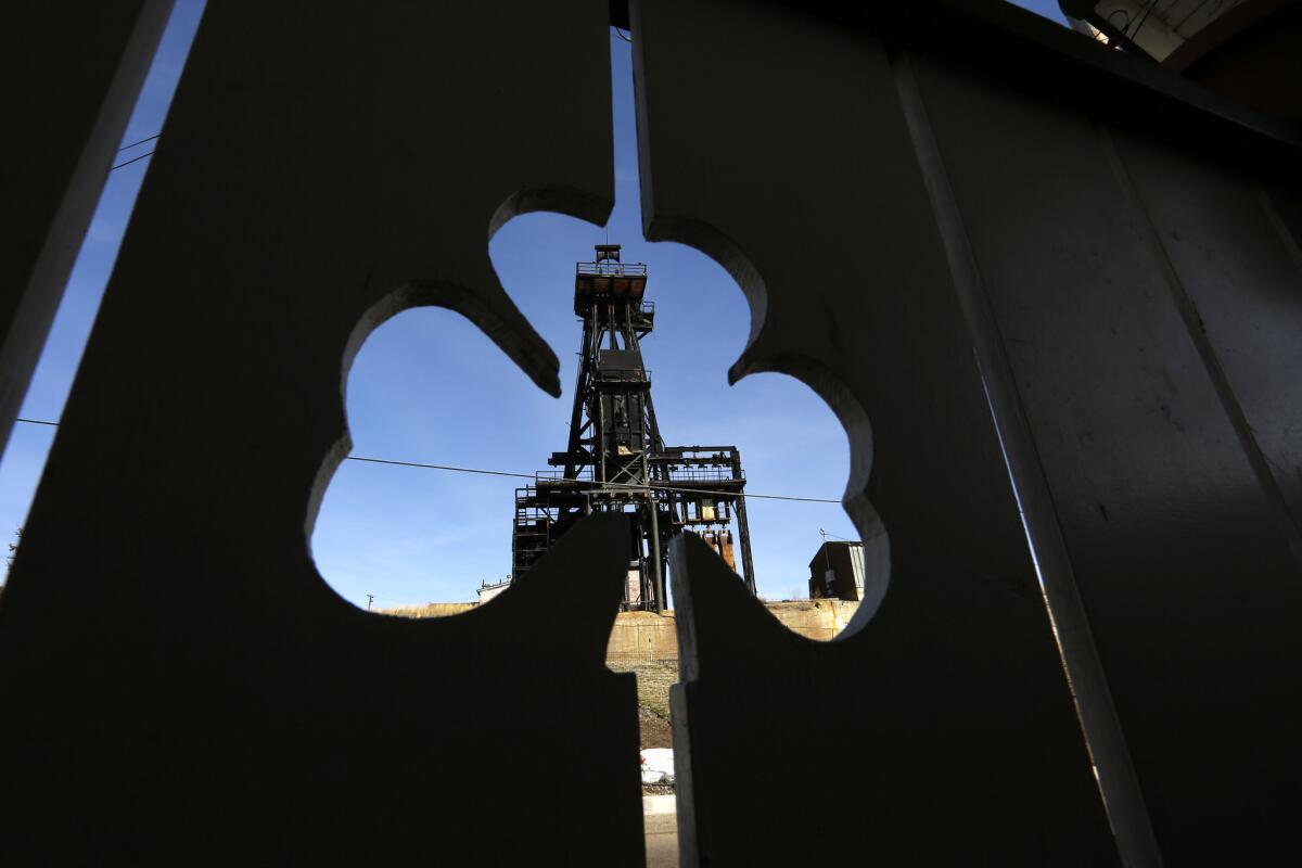 The head frame from Steward Mine in Butte, Montana is framed by a wooden cutout of a shamrock. (Mark Boster / Los Angeles Times)