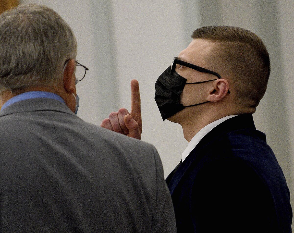 Volodymyr Zhukovskyy of West Springfield, Mass., gestures as the not guilty verdict is read while standing with his attorney, Steve Mirkin, at Coos County Superior Court in Lancaster, N.H., Tuesday, Aug. 9, 2022. The commercial truck driver was charged with negligent homicide in the deaths of seven motorcycle club members in a 2019 crash in Randolph, N.H. (David Lane/The Union Leader, Pool via AP)