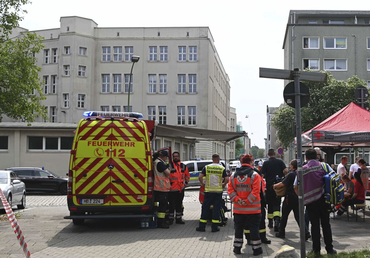 Emergency forces stand near a school in Bremerhaven, Germany, Thursday, May 19, 2022. German police say they have detained a suspect in connection with an attack at a high school in the northern city of Bremerhaven in which one person was injured. Police said the incident happened Thursday morning at the Lloyd high school in the center of the city. (Sina Schuldt/dpa via AP)