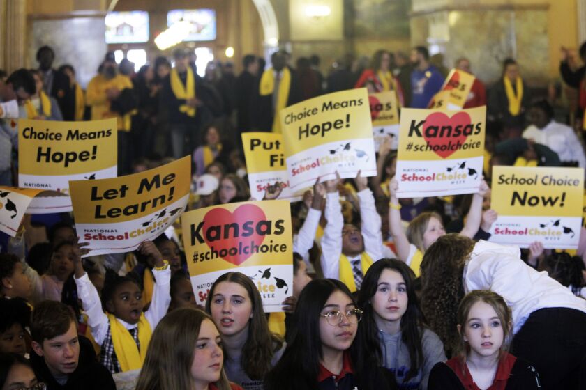 Private and home school students, their parents and advocates crowed part of the second floor of the Kansas Statehouse for a rally for giving parents tax dollars earmarked for public schools and allowing them to spend it how they choose on education, Wednesday, Jan. 25, 2023, in Topeka, Kan.. Years of pandemic restrictions and curriculum battles have emboldened a push from Republican lawmakers and school choice advocates to funnel public funds to private and religious schools in at least a dozen statehouses. (AP Photo/John Hanna)
