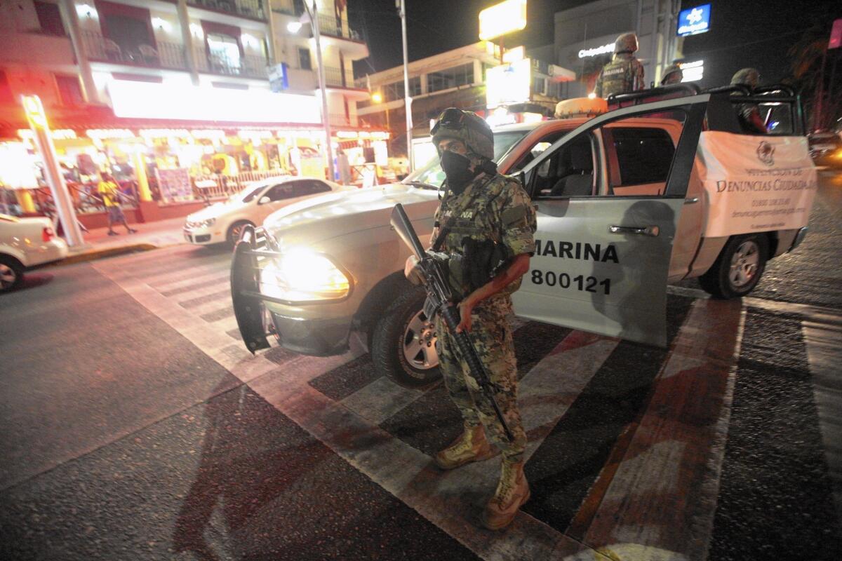 Mexican soldiers patrol Acapulco after attacks by gunmen.