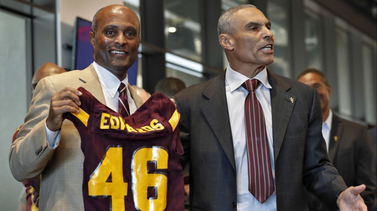 Arizona State coach Herm Edwards, right, at a news conference with athletic director Ray Anderson on Dec. 4.