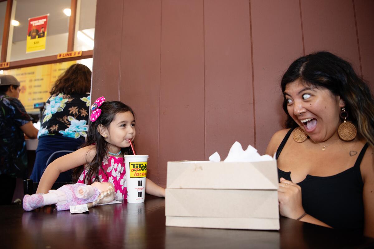 Jazlynn Munoz, left, and Emily Pena enjoy their lunch at Tito's Tacos.