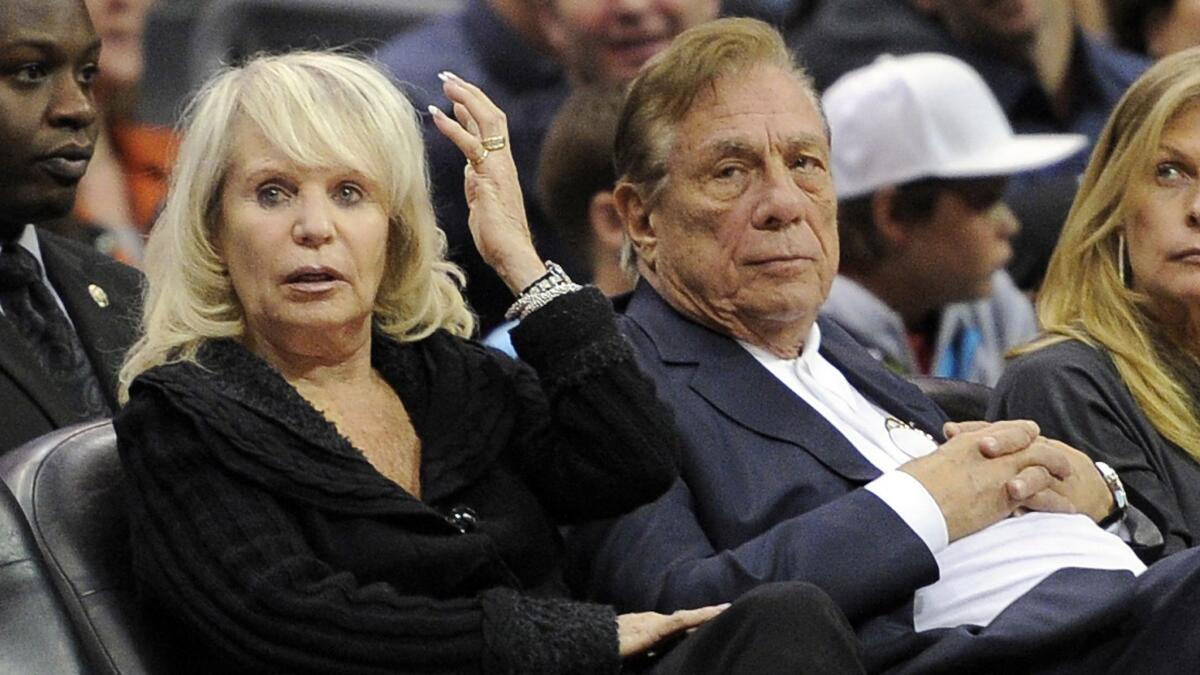 Shelly Sterling, left, sits with her then-husband, Clippers owner Donald Sterling, during a game between the Clippers and Detroit Pistons on Nov. 12, 2010.