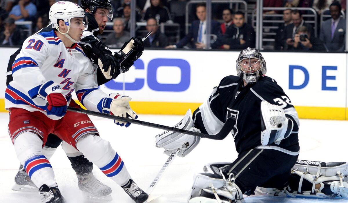 Rangers left wing Chris Kreider watches his rebound shot along with Kings defenseman Jake Muzzin sail past goalie Jonathan Quick in the first period Thursday night.