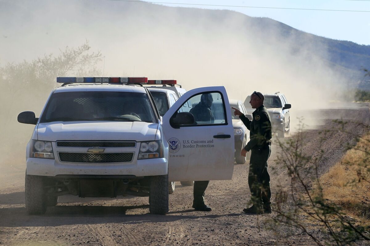 U.S. Customs and Border Protection officers and other law enforcement jurisdictions drive the roads near Bisbee, Ariz. Amid growing backlash, Homeland Security Secretary Jeh Johnson is reconsidering the agency's response to two recommendations.