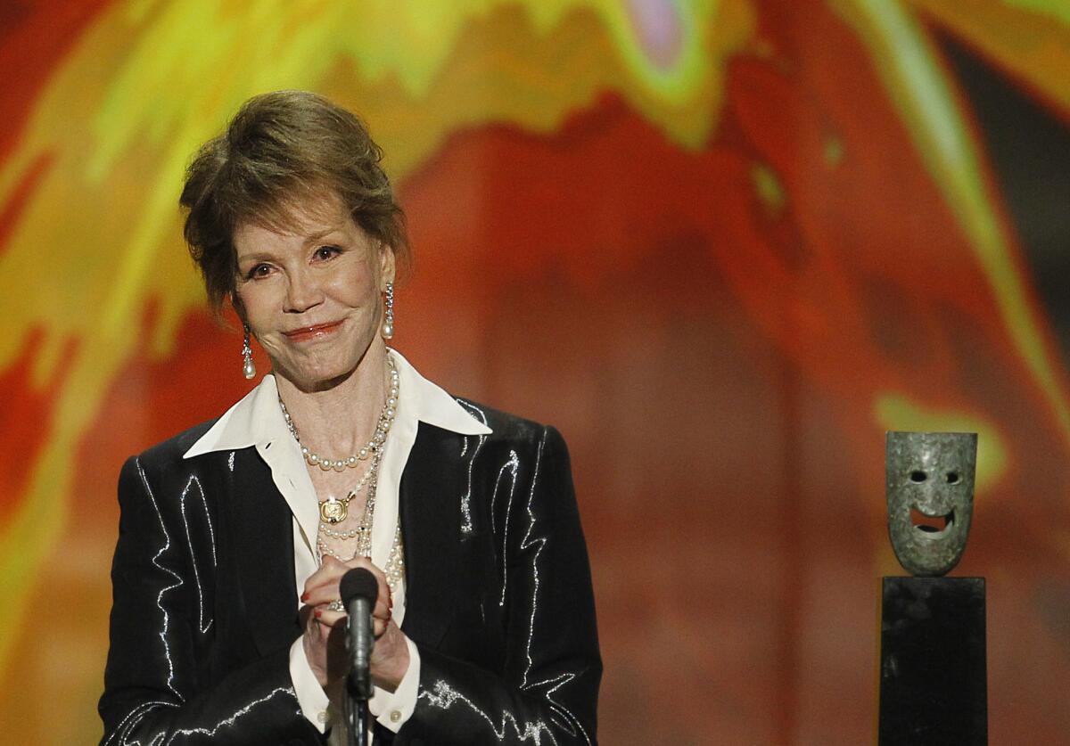 Mary Tyler Moore accepts her Screen Actors Guild Life Achievement Award during the 18th SAG Awards show at the Shrine Auditorium in Los Angeles in 2012.