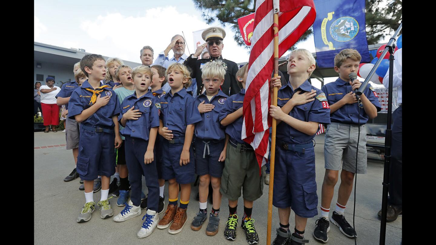 Members of Boy Scout Troop 325 recite the Pledge of Allegiance during a flag ceremony Thursday morning in a Veterans Day commemoration at Mariners Elementary School in Newport Beach.