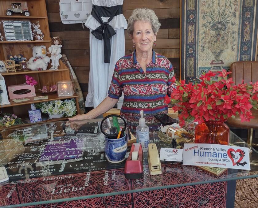 Charlotte Jensen sells items in blended shops that include vendor booths at the corner of Eighth and Main streets.