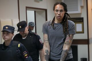WNBA star and two-time Olympic gold medalist Brittney Griner is escorted from a courtroom on Aug. 4, 2022.