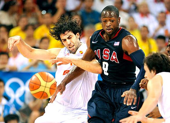 Dwayne Wade of the U.S. battles Spain's Berni Rodriguez for the ball in the gold medal match at the 2008 Beijing Olympics.