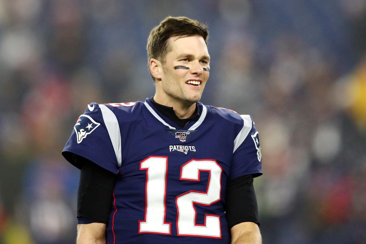 Tom Brady of the New England Patriots cheers as he runs on to the News  Photo - Getty Images