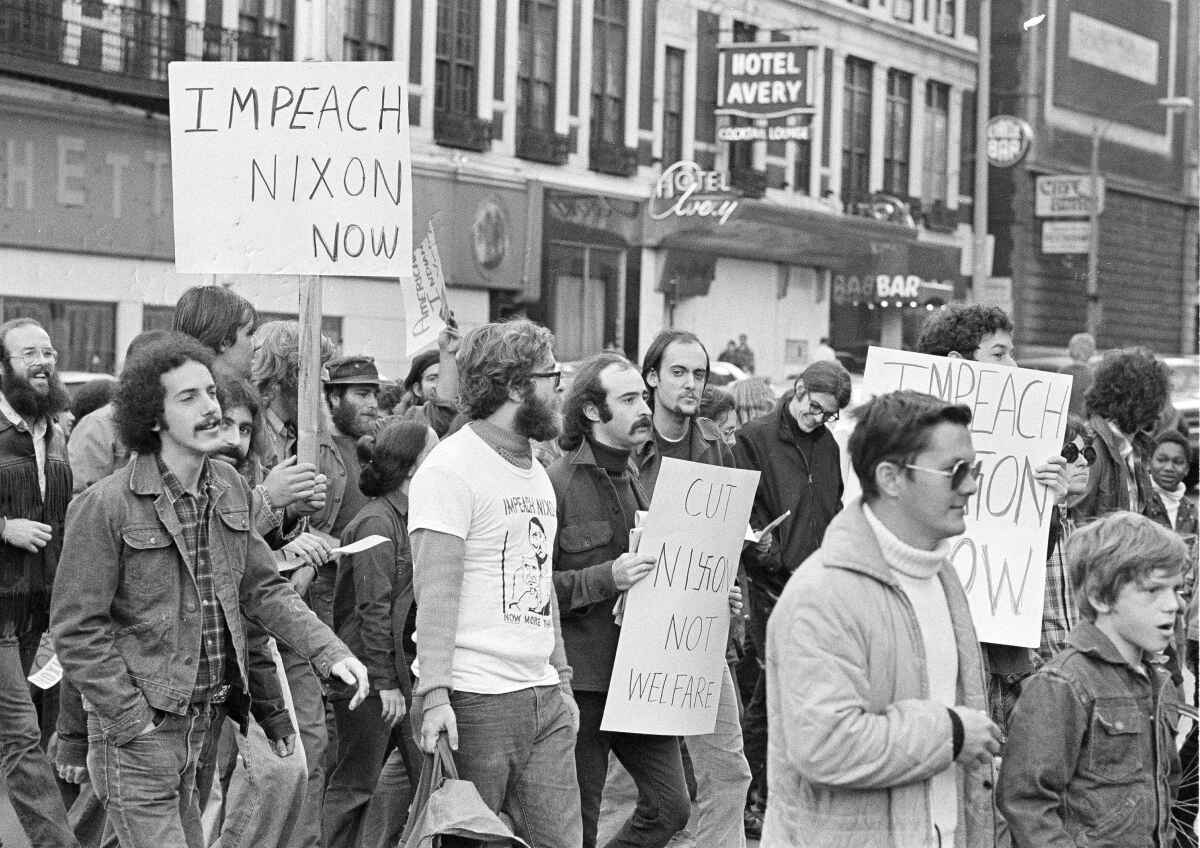 Black and white image of people calling for the impeachment of Richard Nixon