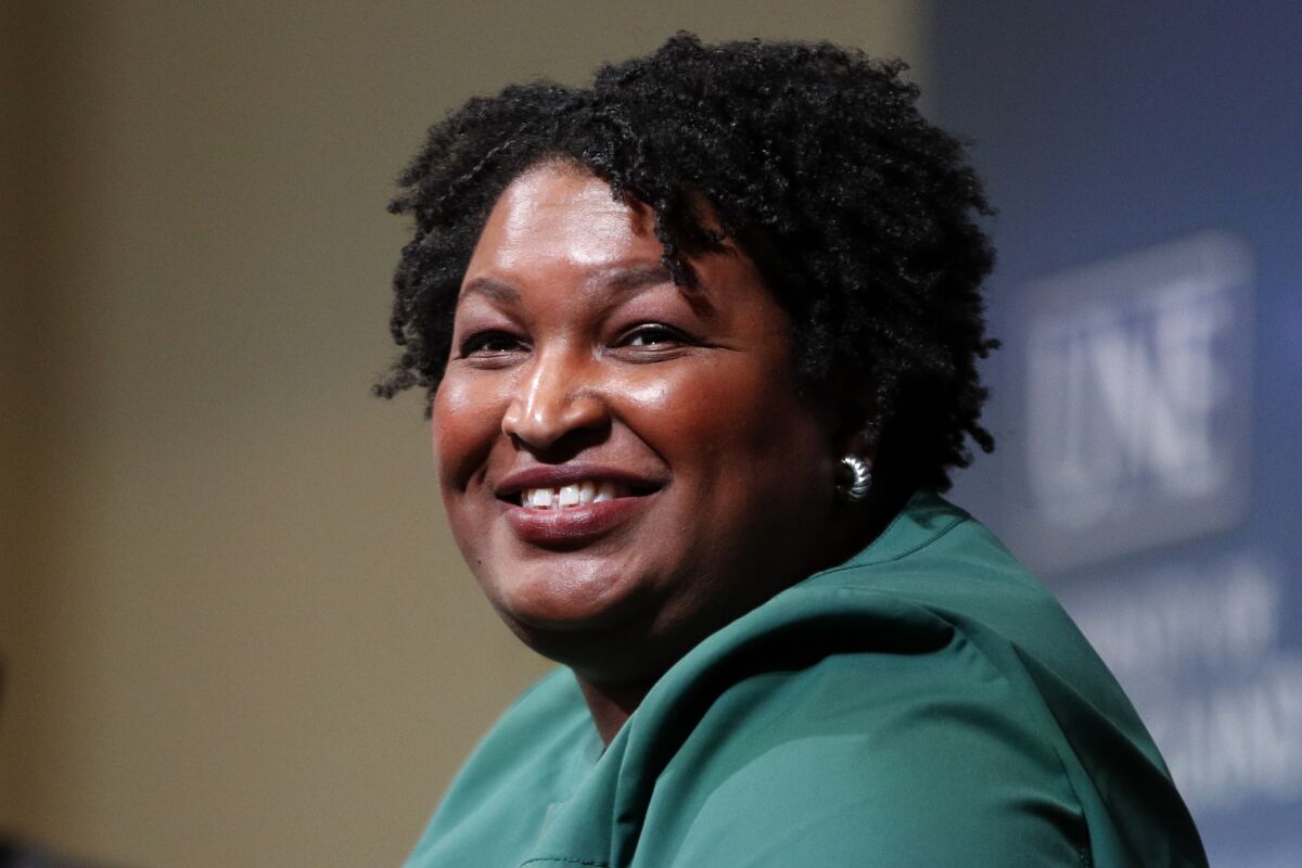 FILE - Stacey Abrams, a Georgia Democrat who has launched a multimillion-dollar effort to combat voter suppression, speaks at the University of New England in Portland, Maine on Jan. 22, 2020. Berkley announced Tuesday that it had acquired rights to three out-of-print novels by Abrams that she had written nearly 20 years ago under the name Selena Montgomery. Berkley, a Penguin Random House imprint, will begin reissuing the books; “Rules of Engagement,” “The Art of Desire” and “Power of Persuasion," in 2022. (AP Photo/Robert F. Bukaty, File)