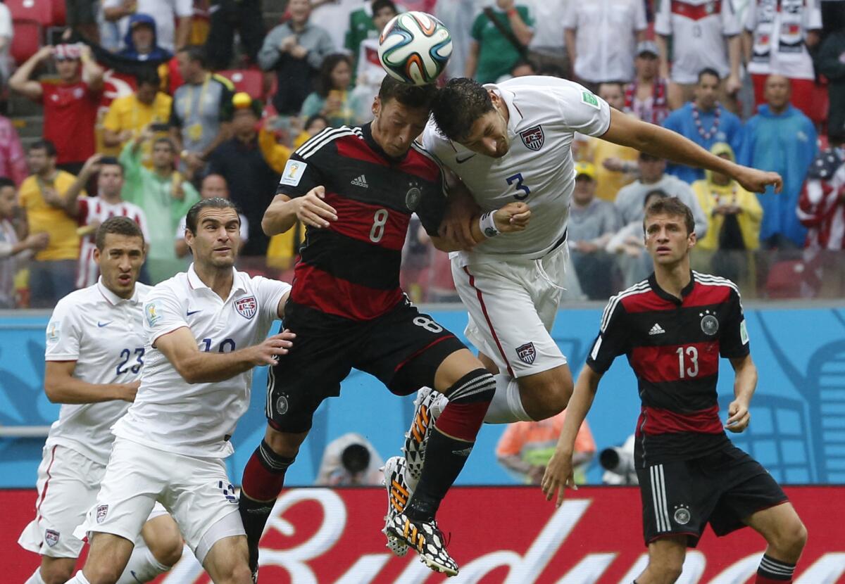 Germany's Mesut Ozil, center, shown going for a header with the U.S.'s Omar Gonzalez, decided against fasting during holy month of Ramadan this year because of the demands of the World Cup.