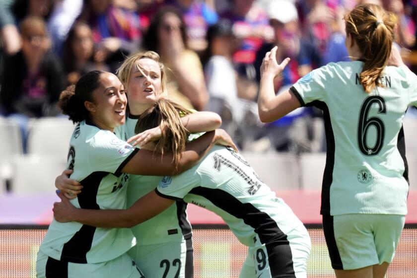 Chelsea's Erin Cuthbert, 2nd left, celebrates with her teammates after scoring the opening goal during the women's Champions League semifinals, first leg, soccer match between FC Barcelona and Chelsea FC at the Olympic Stadium, in Barcelona, Spain, Saturday, April 20, 2024. (AP Photo/Jose Breton)