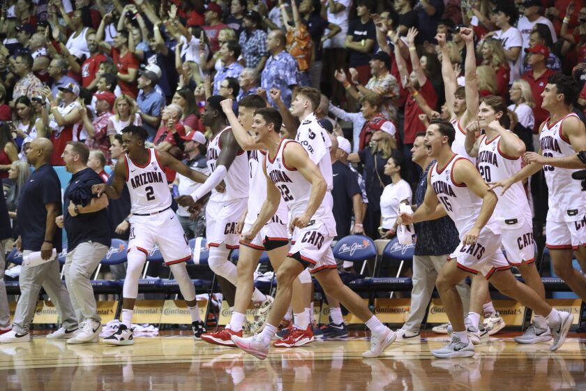 Arizona players run onto the court after the team's win over Creighton in an NCAA college basketball game Wednesday, Nov. 23, 2022, in Lahaina, Hawaii. (AP Photo/Marco Garcia)