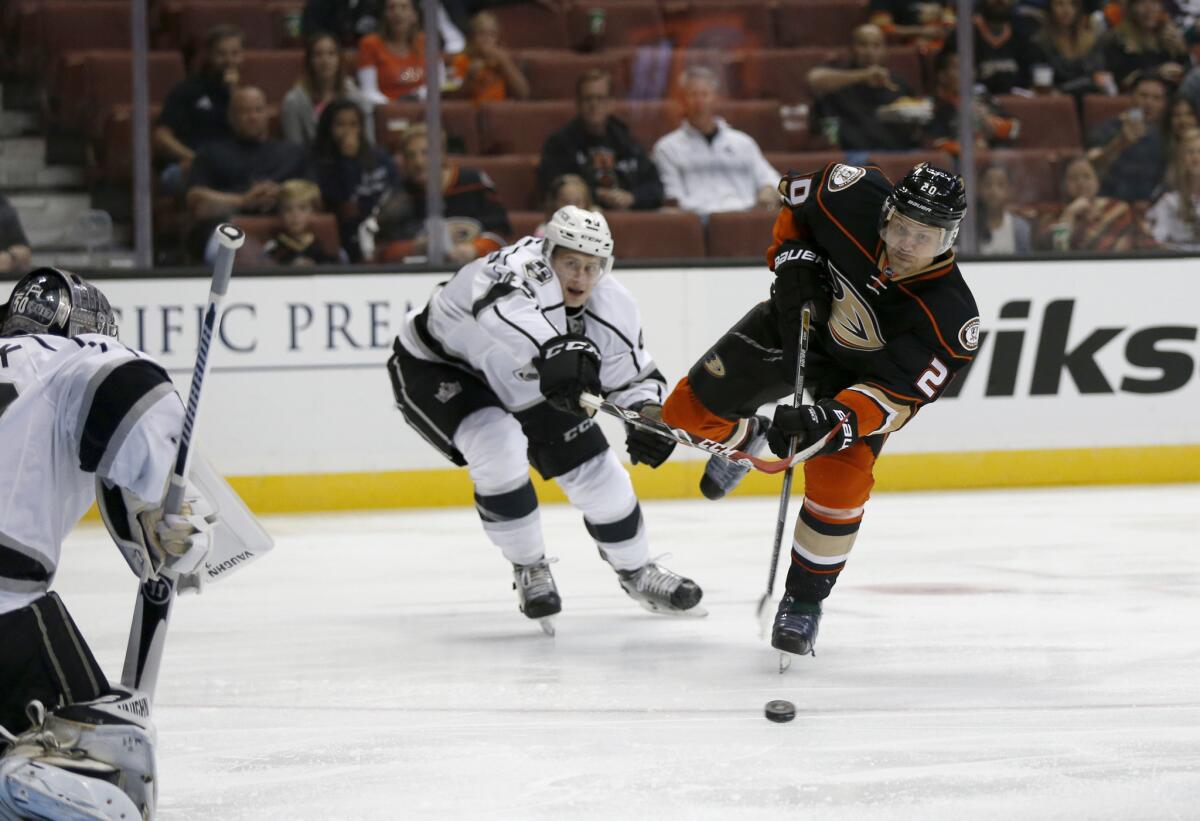 Kings defender Alex Lintuniemi, left, tries to block Ducks left wing Sean Bergenheim's shot on goal in the first period during a preseason game at Honda Center on Oct. 2.