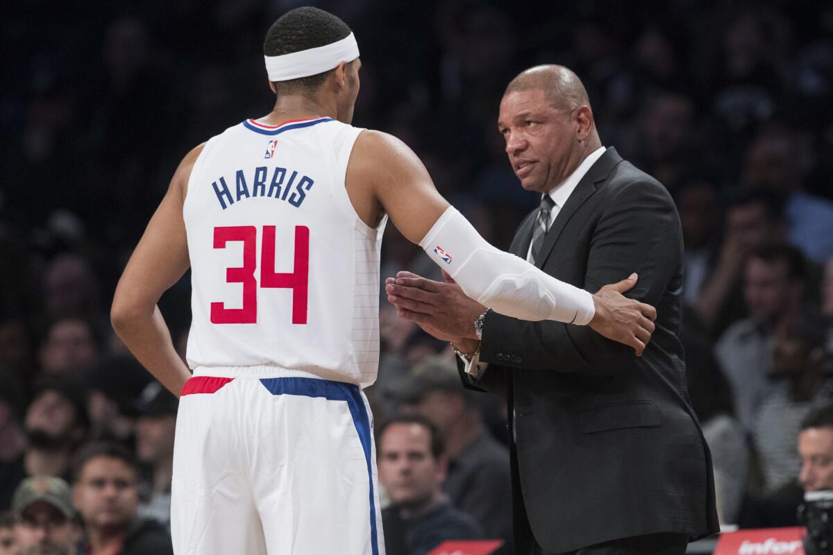 Los Angeles Clippers head coach Doc Rivers talks to forward Tobias Harris (34) during the second half of an NBA basketball game against the Brooklyn Nets, Saturday, Nov. 17, 2018, in New York. The Clippers won 127-119.