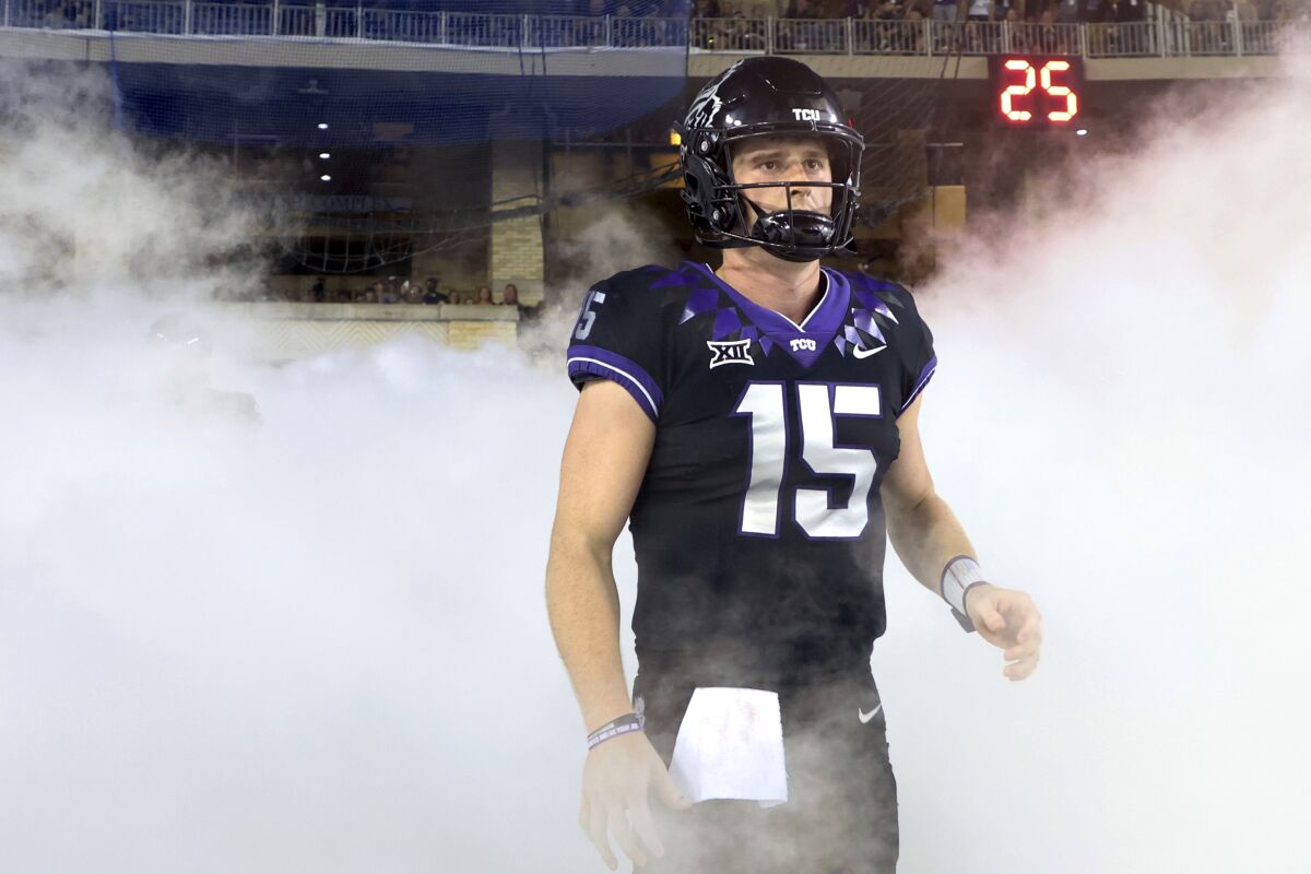 FILE - TCU quarterback Max Duggan (15) stands at a tunnel exit during team introductions before an NCAA college football game against Kansas State in Fort Worth, Texas, on Oct. 22, 2022. Duggan’s 41st career start for third-ranked TCU will come in the Big 12 championship game on Saturday, Dec, 3, 2022, with the undefeated Horned Frogs on the brink of making the College Football Playoff. (AP Photo/Richard W. Rodriguez, File)