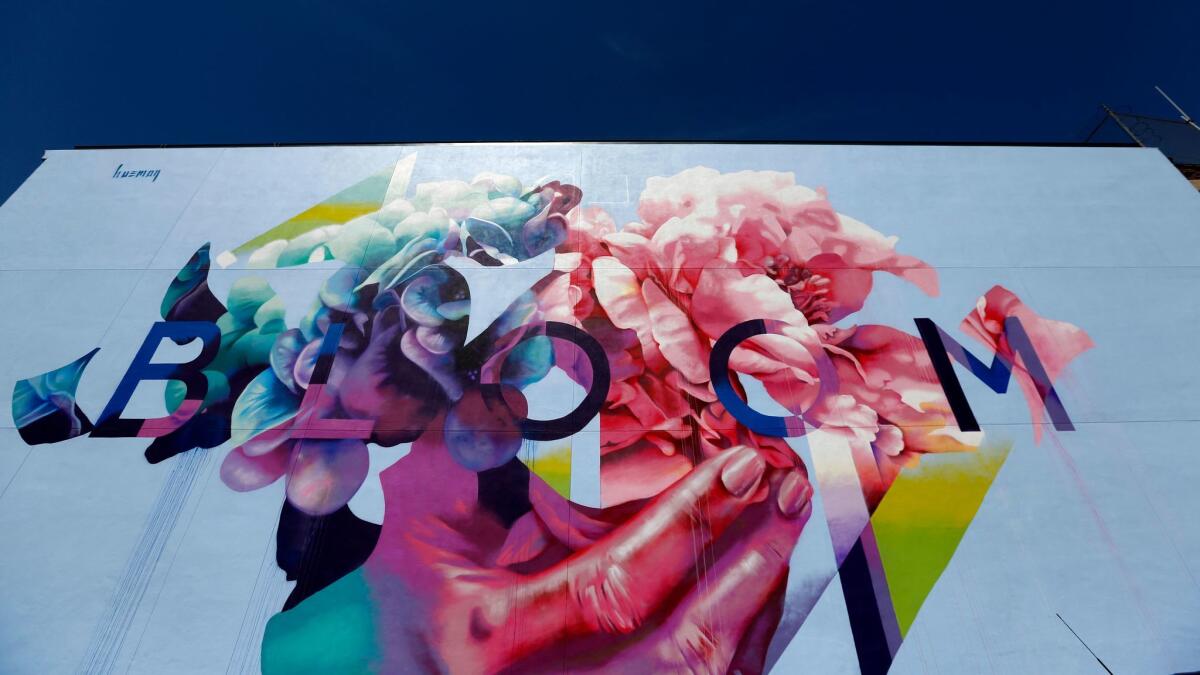 "Bloom" by artist Hueman unfurls on the Neptune Building in Los Angeles' Arts District.