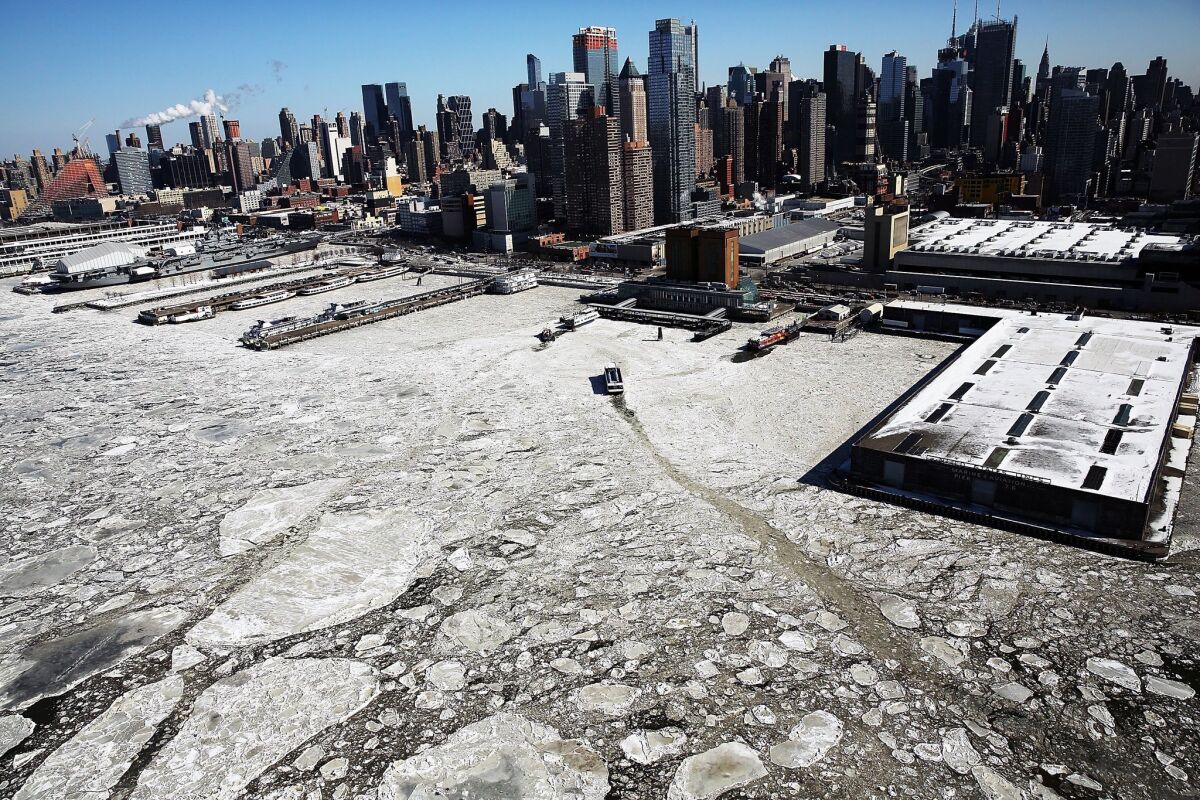 Ice floes are viewed along the Hudson River in Manhattan on a frigidly cold Friday in New York. Much of the East Coast is experiencing unusually cold weather and snow.