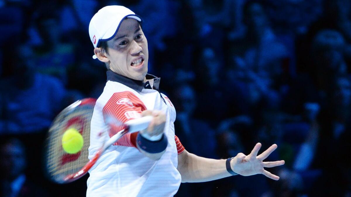 Kei Nishikori returns a shot during his victory over Andy Murray at the ATP Finals in London on Sunday.