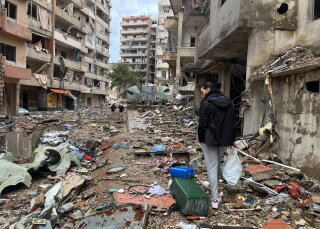 Abbas Aqel, 25, takes stock of what remains of his family apartment in Beirut's southe