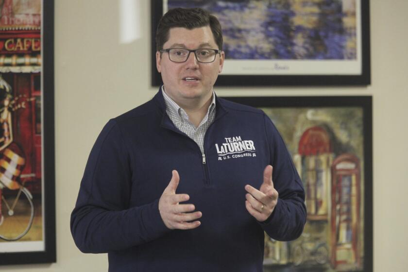 FILE - U.S. Rep. Jake LaTurner, R-Kan., speaks to Republican volunteers during a campaign stop with other GOP candidates, Nov. 7. 2022, in Topeka, Kan. LaTurner announced Thursday, April 18, 2024, that he is not running for reelection this year in his GOP-leaning eastern Kansas district so that he can spend more time with his four young children. (AP Photo/John Hanna, File)