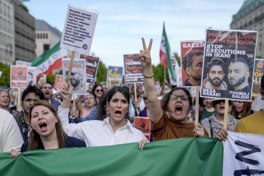 FILE - Protesters attend a rally against a death sentence given to Toomaj Salehi, a popular rapper in Iran and to support to the women of Iran, in Berlin, Germany, Sunday, April 28, 2024. Iran's Supreme Court overturned the death sentence of a government critic and a popular hip-hop artist, Toomaj Salehi — who came to fame over his lyrics about the death in police custody of Mahsa Amini in 2022 — his lawyer Amir Raisian said Saturday, June 22, 2024.(AP Photo/Ebrahim Noroozi, File)