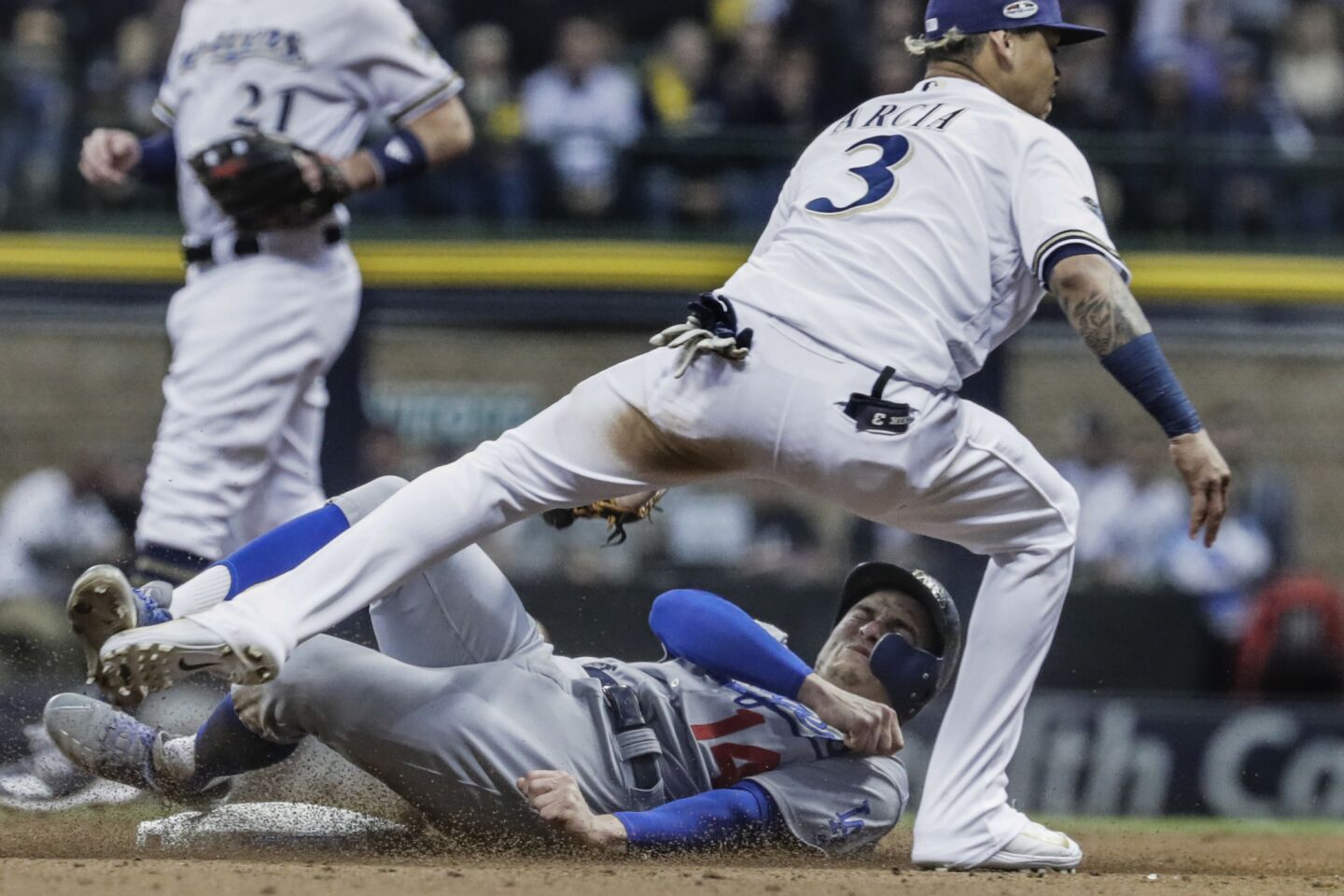 Brewers shortstop Orlando Arcia tags Kiké Hernandez who is caught stealing in the seventh inning in game seven.