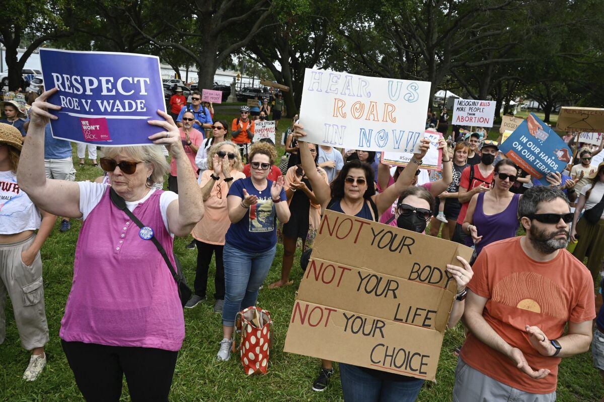 Protesters listen to speeches and display their signs on  June 24, 2022, at North Straub Park in St. Petersburg, Fla.
