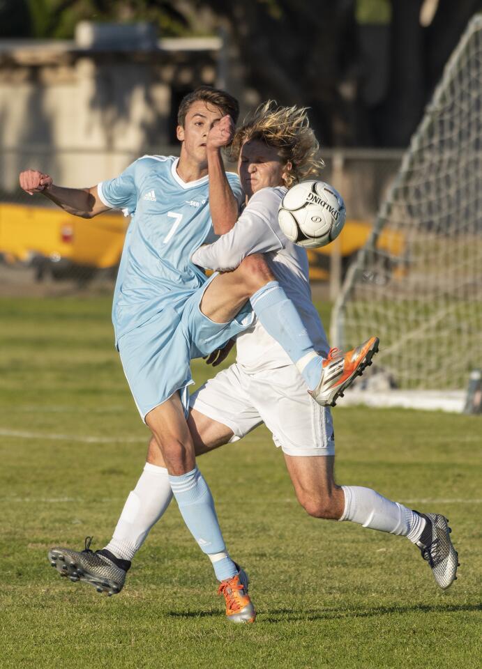 Corona del Mar's Niko Urban battles for a ball with Fountain Valley's Cantor Wright during a game on Friday, January 4.