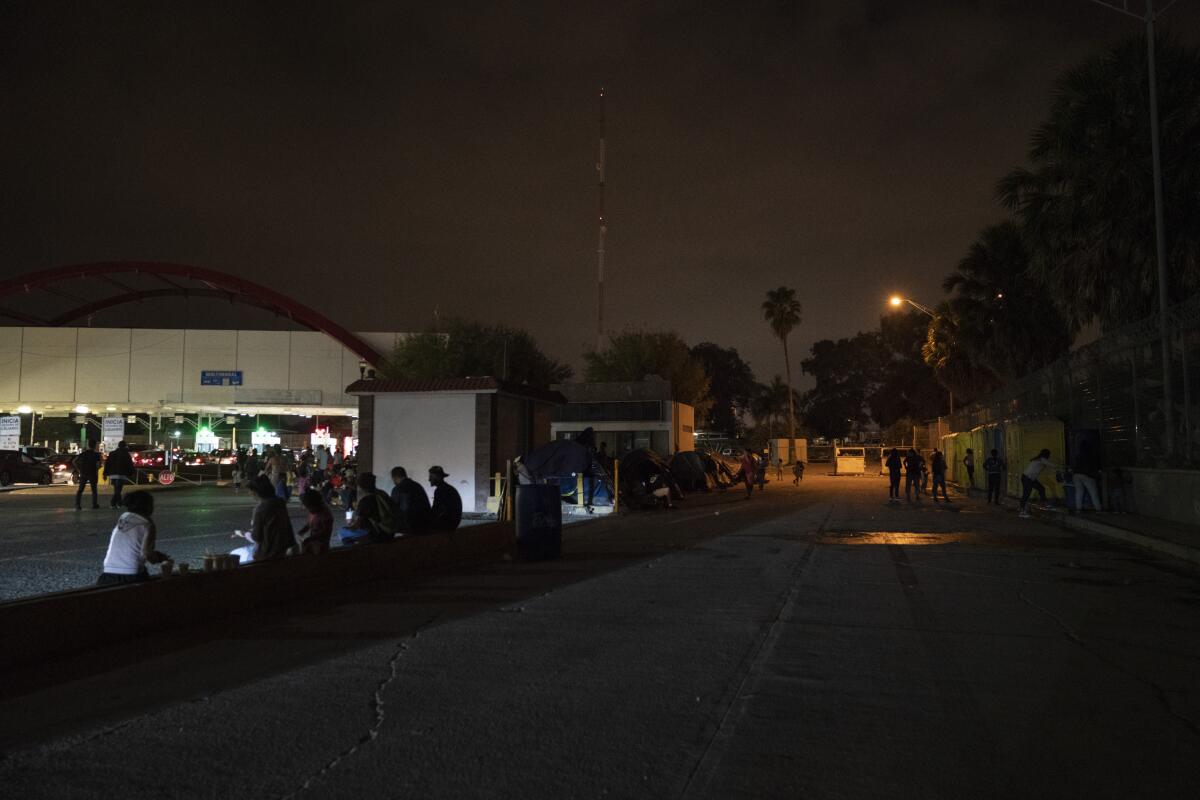 Migrants near the camp for asylum seekers in Matamoros.