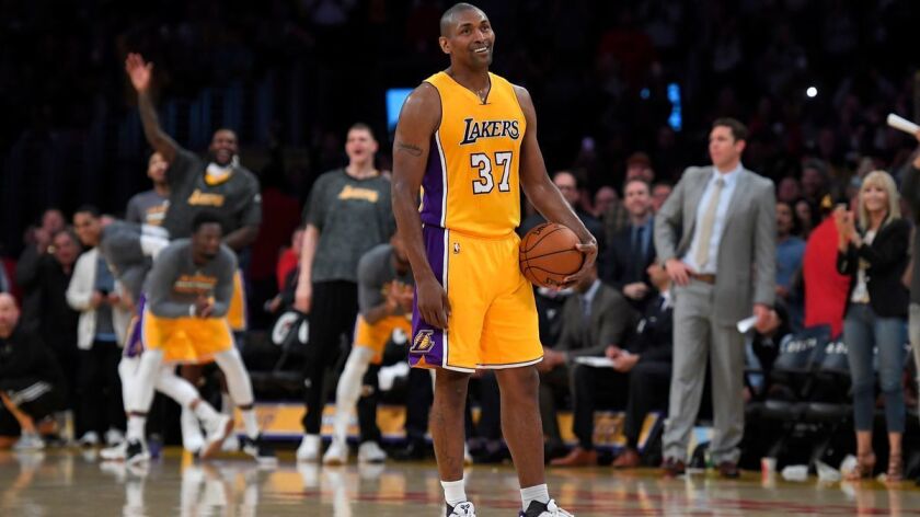 Lakers forward Metta World Peace stands on the court while teammates and fans cheer as the 24 second clock runs out near the end of the game against the New Orleans Pelicans, Tuesday.