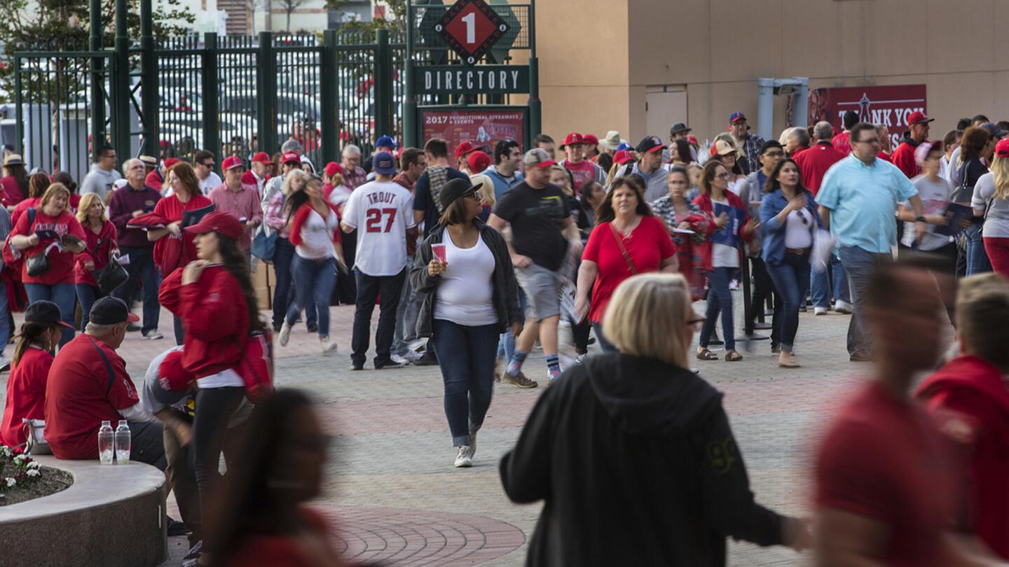 Angels fans pour into the stadium on opening night before a game against the Mariners at Angel Stadium of Anaheim.