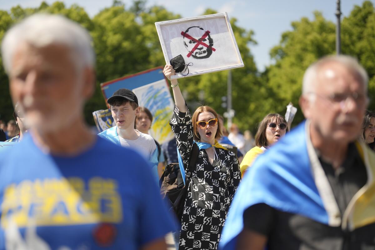 Woman holding an anti-Vladimir Putin sign