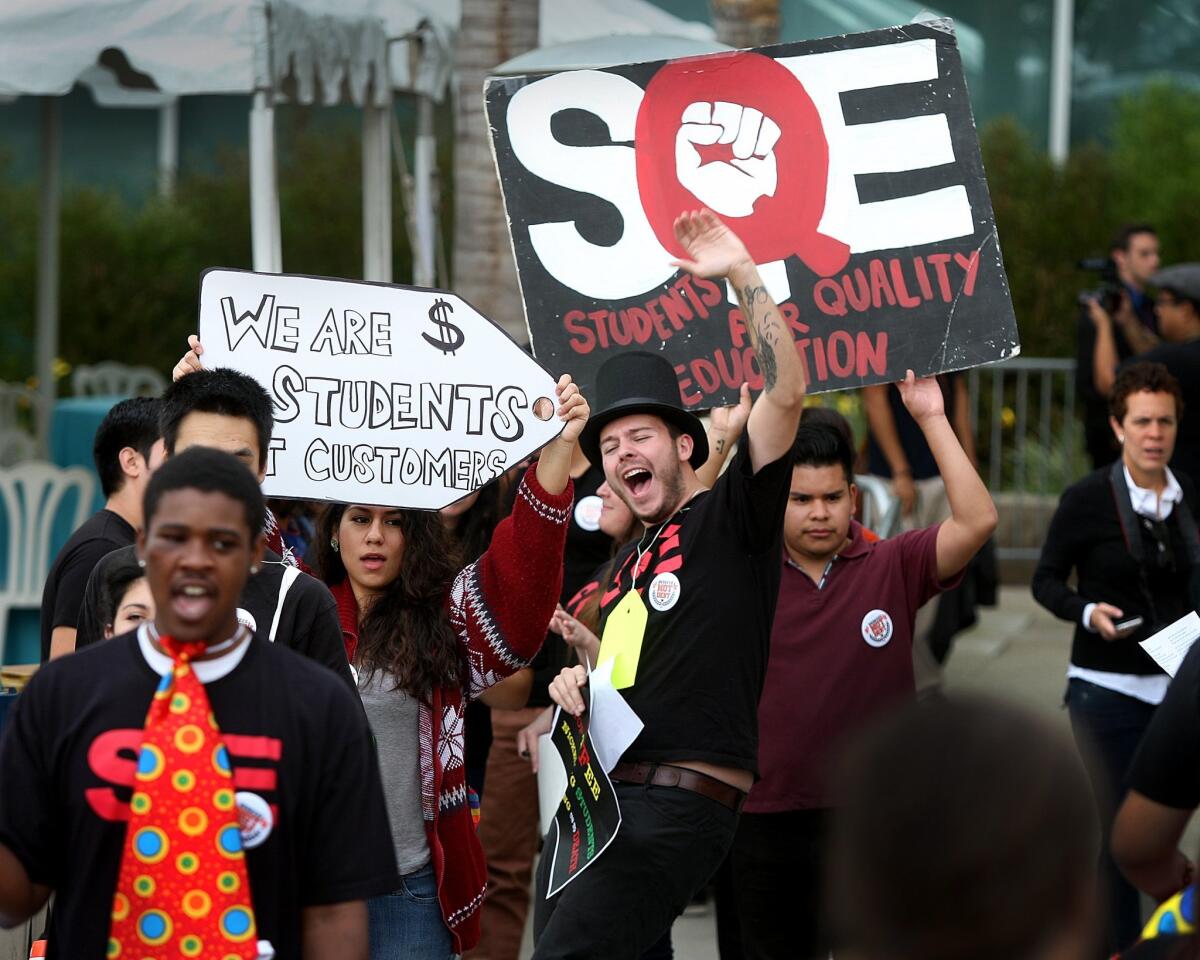 Cal State Dominguez Hills student Robert DeWitz, center, leads chants as students from across the state demonstrate against higher fees outside the Cal State trustees' Long Beach meeting.