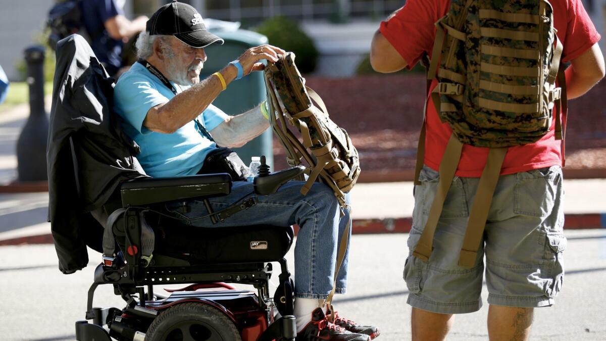 Richard Rodriguez, 82, a homeless disabled veteran, receives a backpack and dinner at a veterans' welcome center in Los Angeles in October.